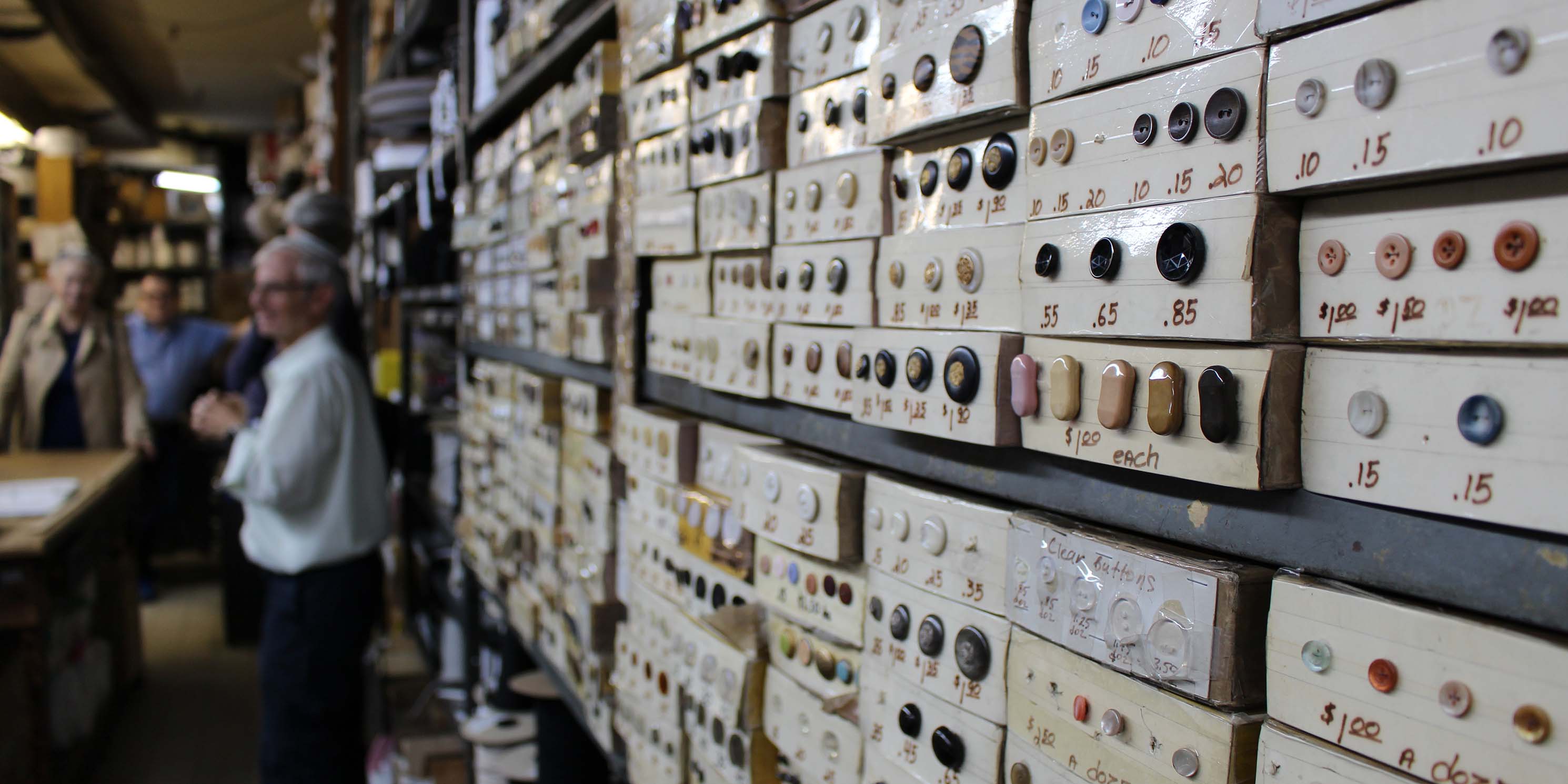 buttons on display wall at Garment District shop