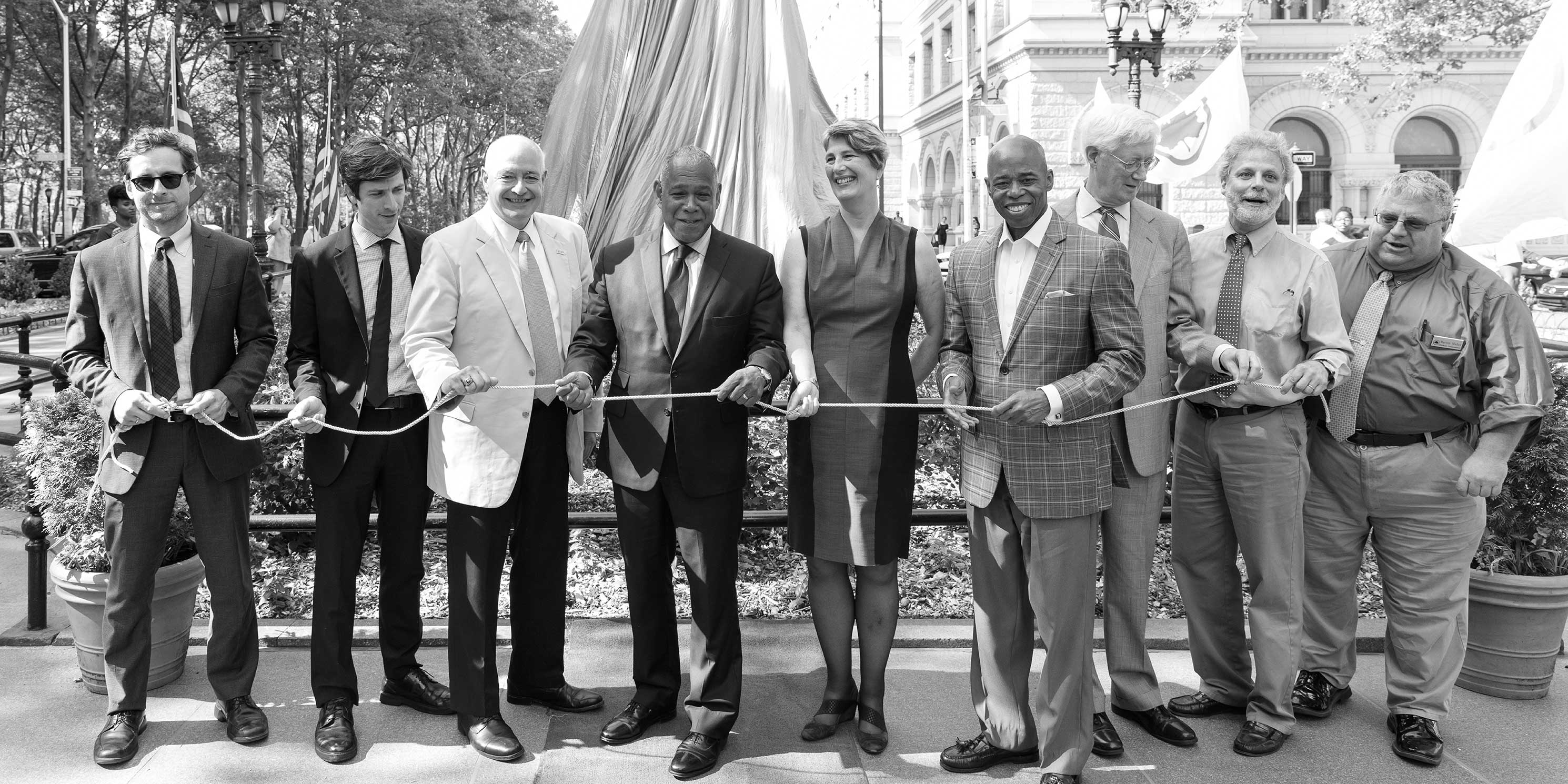Leaders hold ribbon at Henry Ward Beecher Monument Dedication in Brooklyn