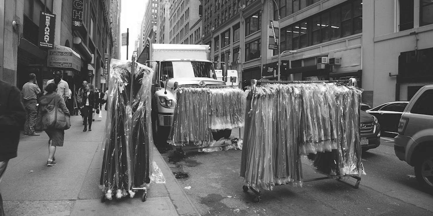 racks of clothes on the street in New York City's Garment District