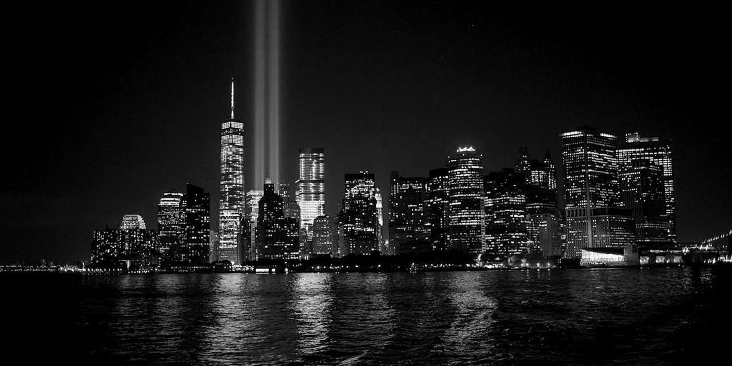 Tribute in Light spotlight beams shine into the night sky in Lower Manhattan