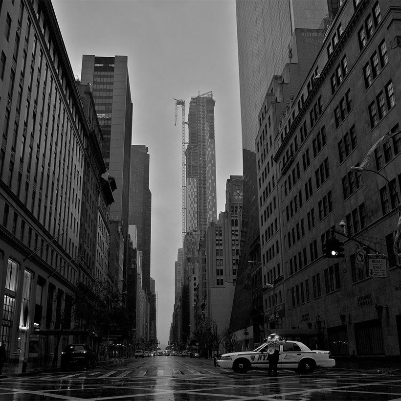 Police officer directs traffic under rain and dark sky from Hurricane Sandy. Photo: Wikimedia Commons, Jordan Balderas.