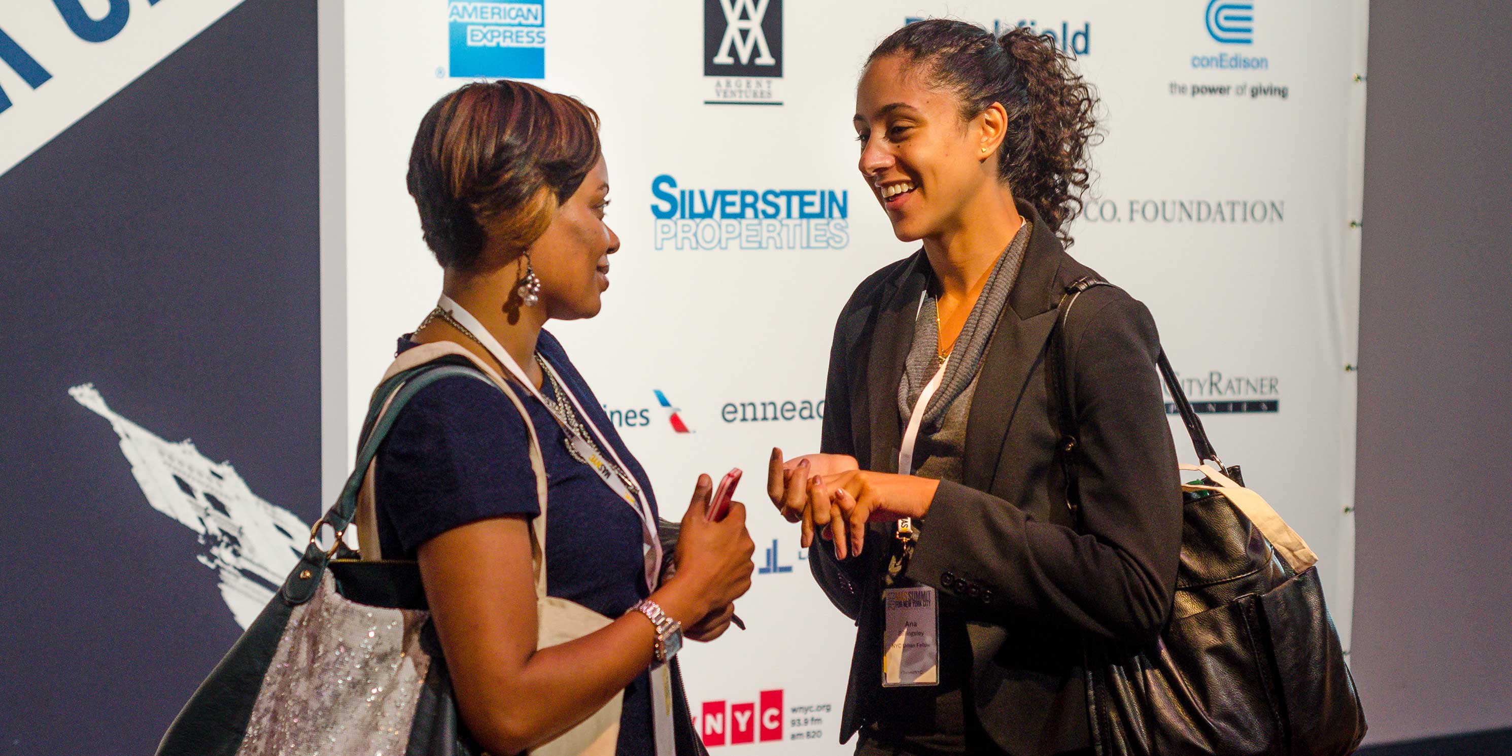 two young women talk at the Summit