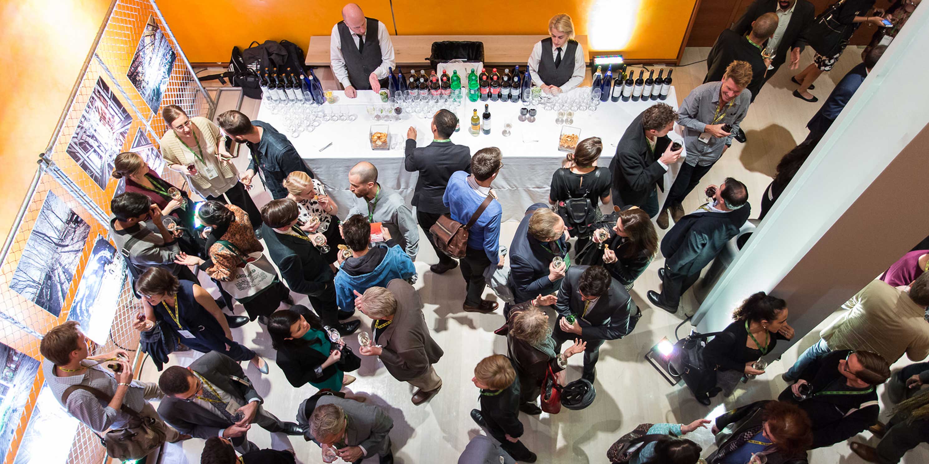 attendees drink and talk at a party after the Summit