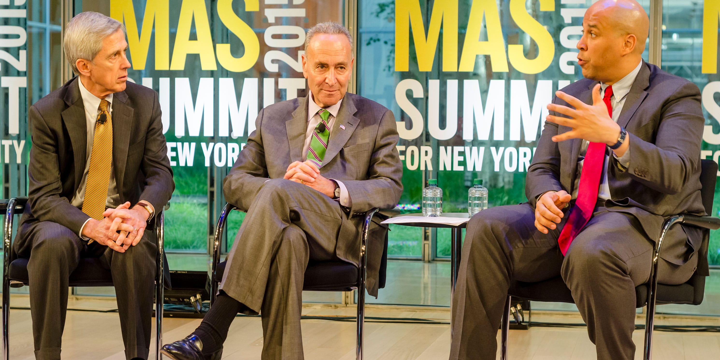 Chuck Schumer and Cory Booker on stage at the Summit