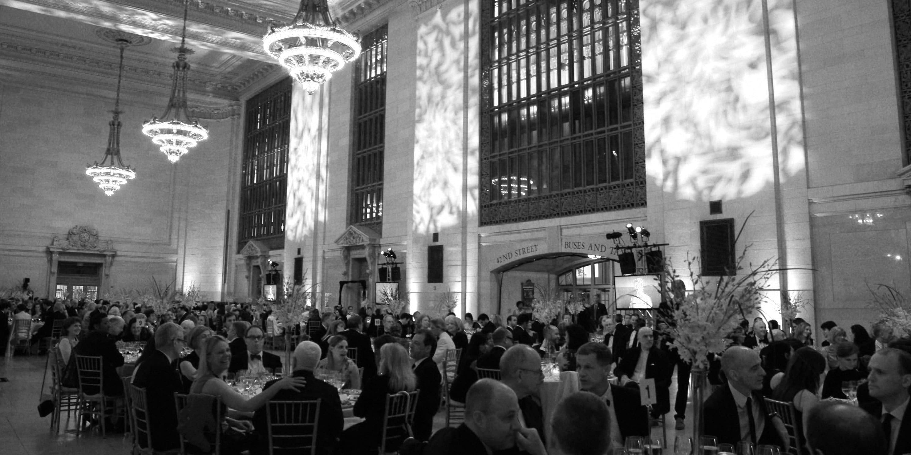 people dine at tables in Vanderbilt Hall, within Grand Central Terminal