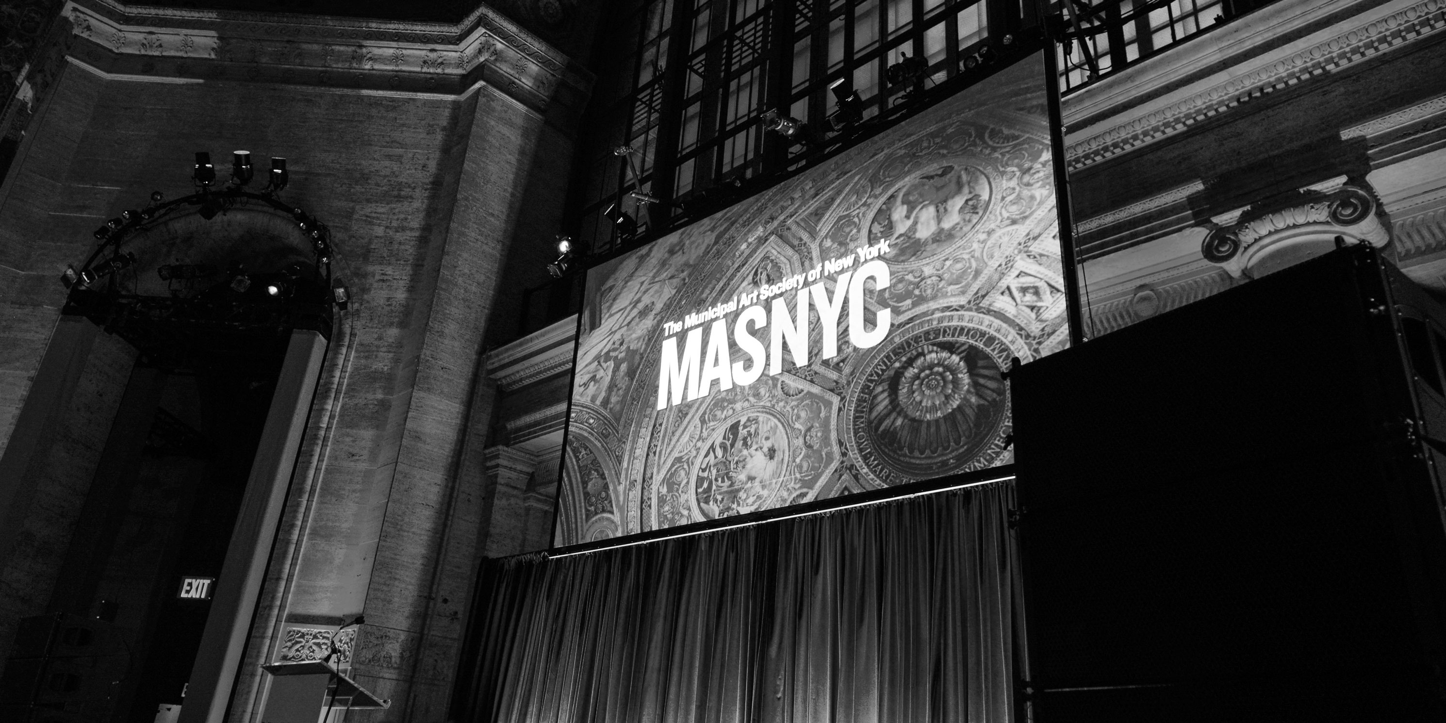 large movie screen with company logo on it at the Gala