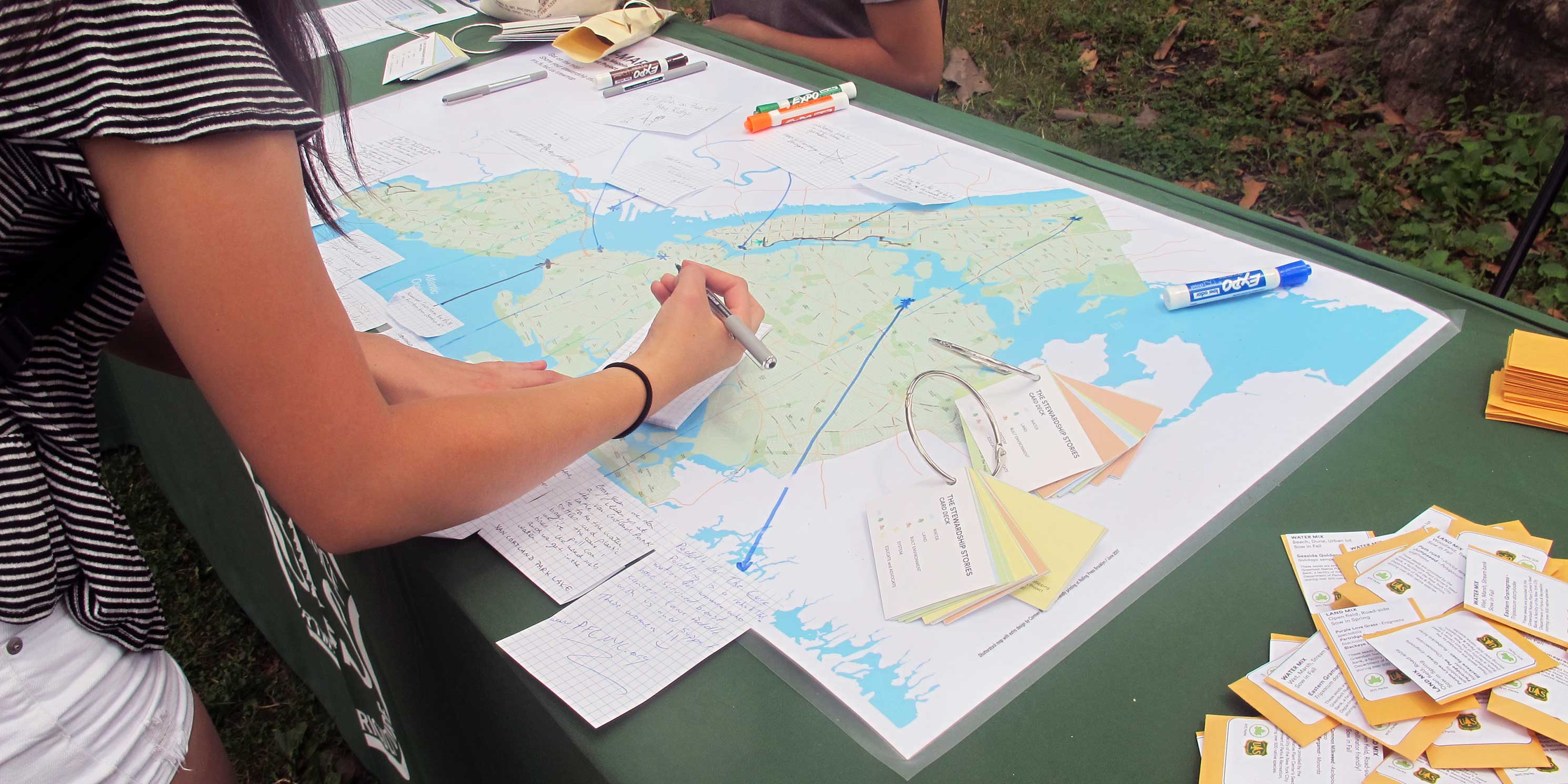 A woman draws on a map at a US Forest Service Urban Ranger Station in New York City