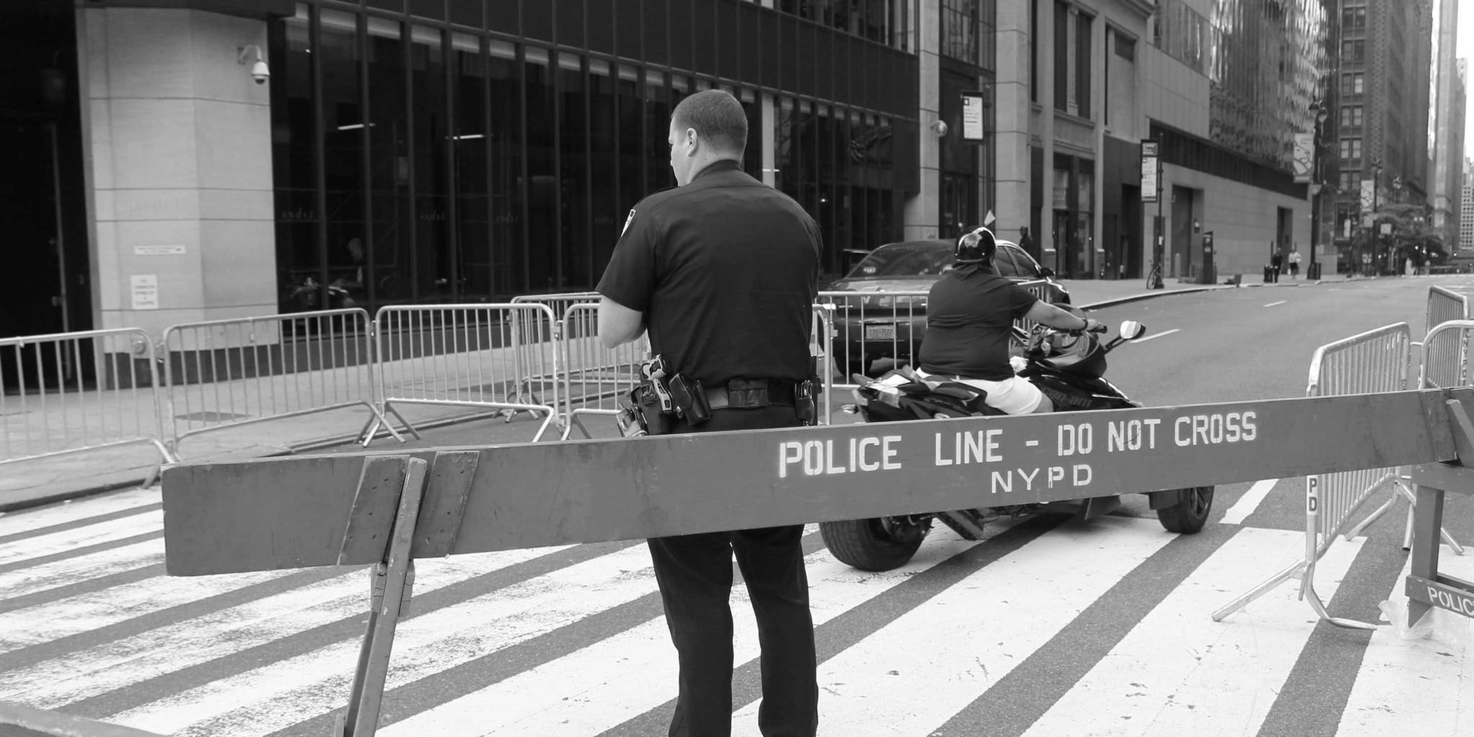 New York Police Department officer stands at a barrier