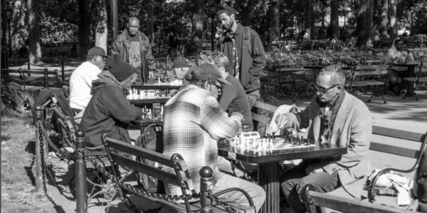 Men playing chess in the park. Photo: Giles Ashford.