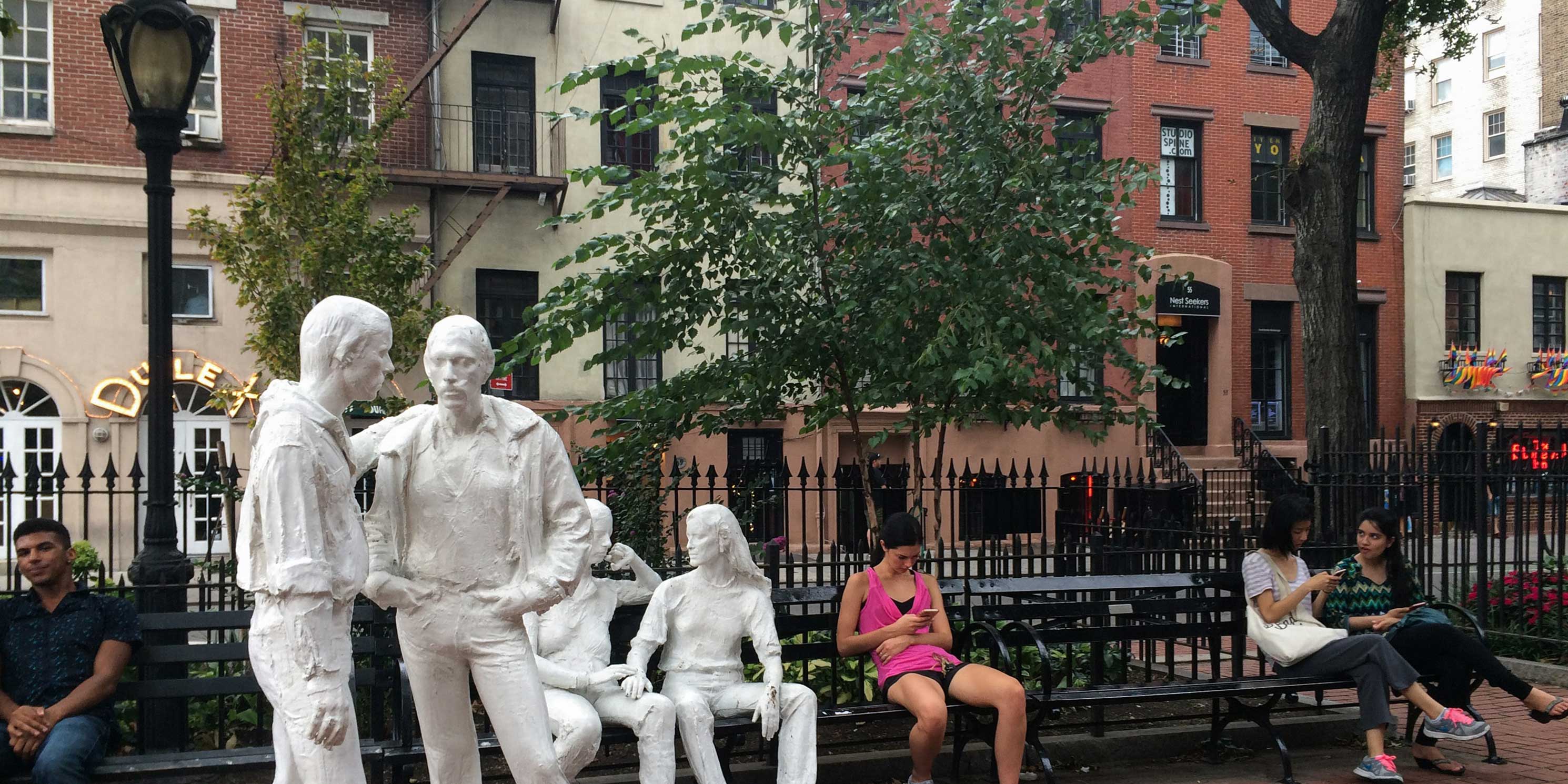 statues in park outside Stonewall Inn