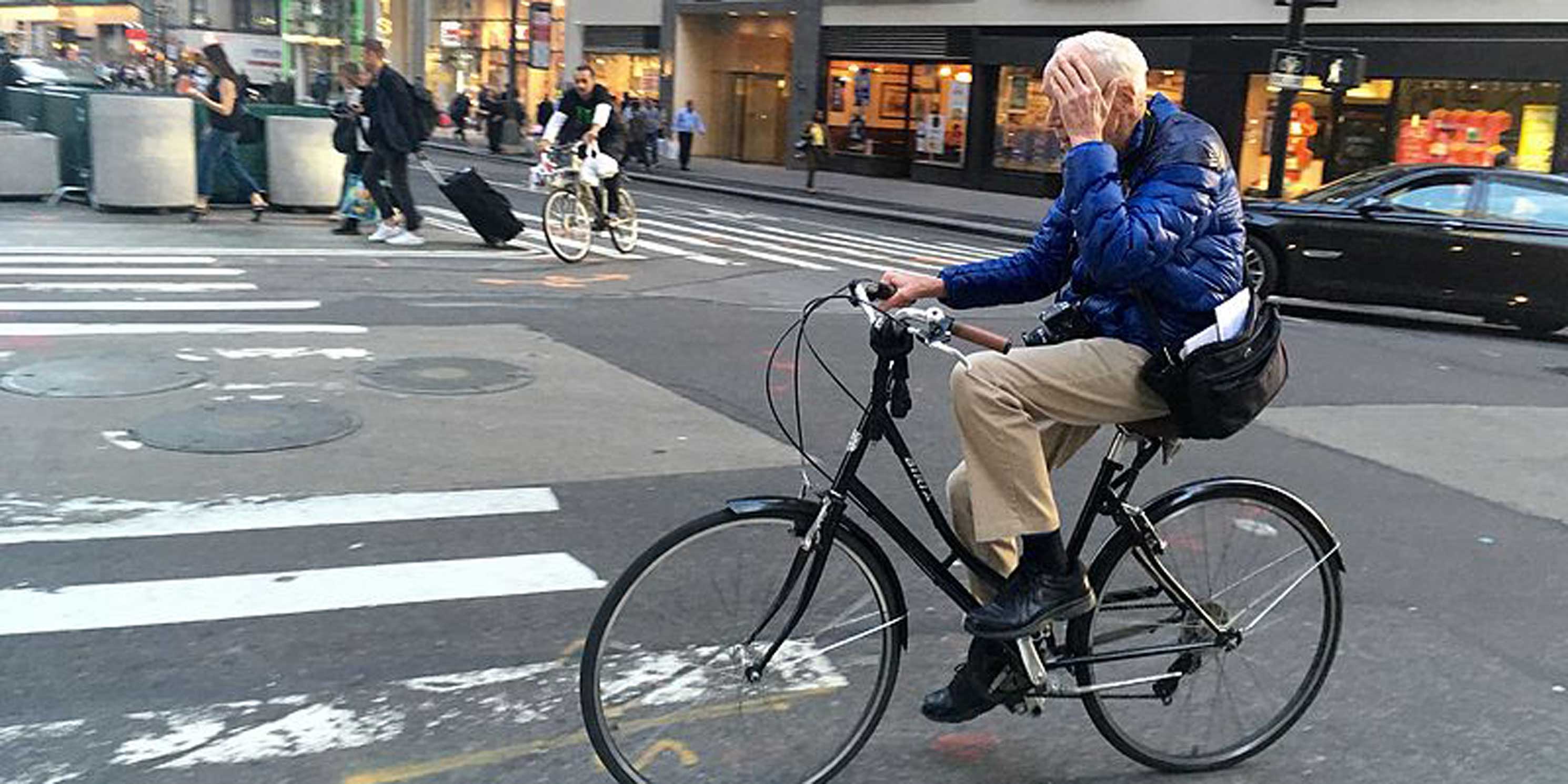 Bill Cunningham rides a bike