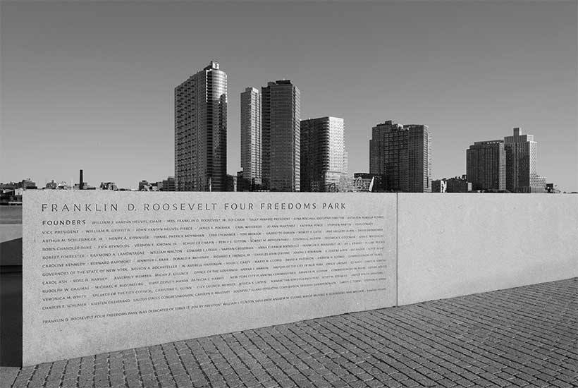 Wall with names of park founders on it at Four Freedoms Park. Long Island City can be seen in the background.