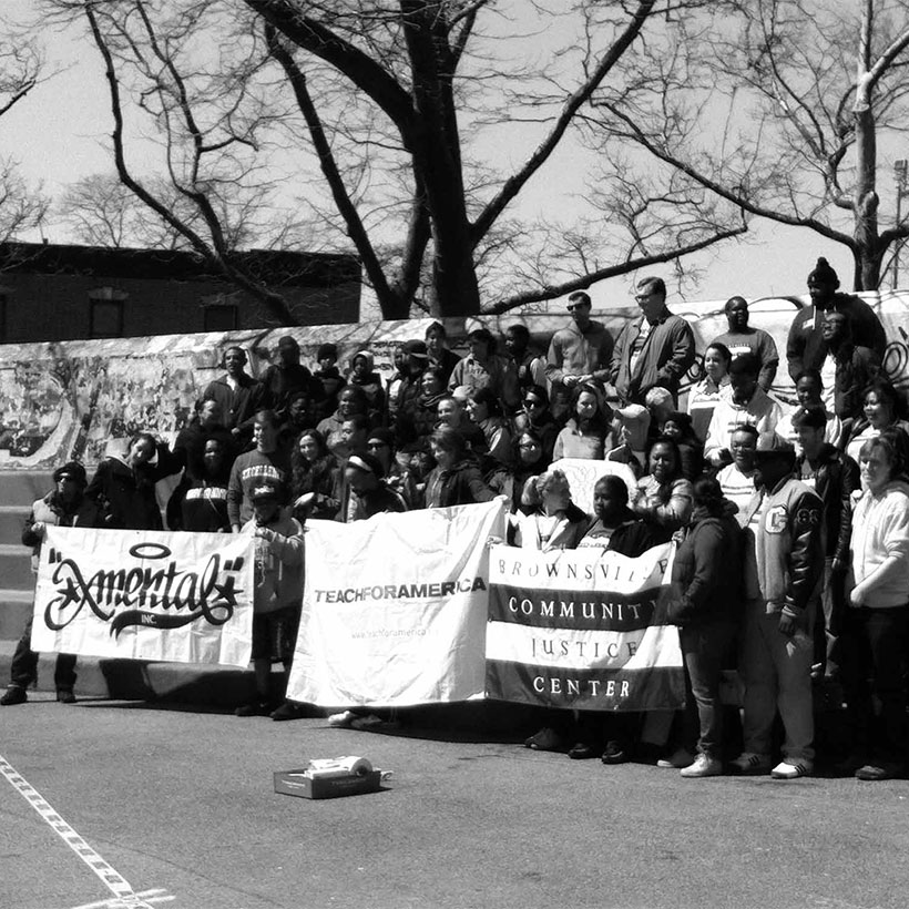 community groups pose for photo in Betsy Head Park