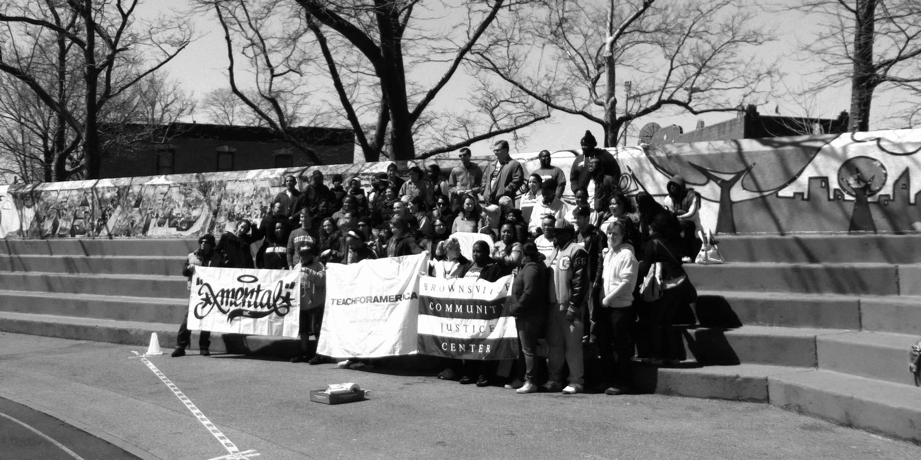 community groups pose for photo in Betsy Head Park