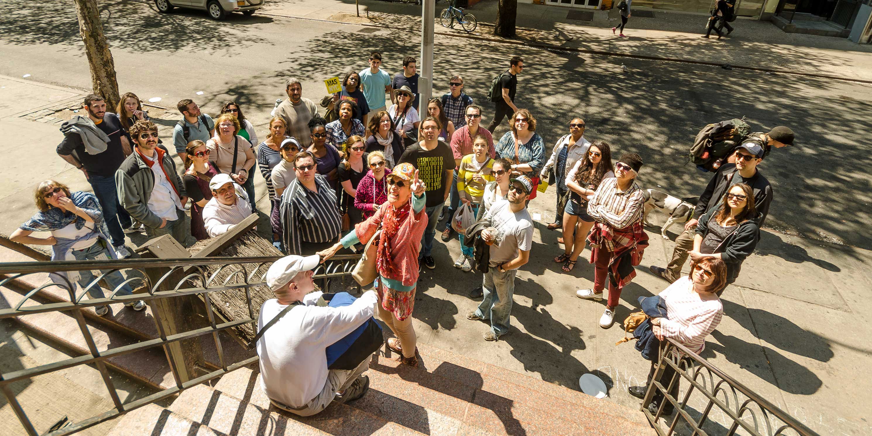 A Jane's Walk group listens to their guide