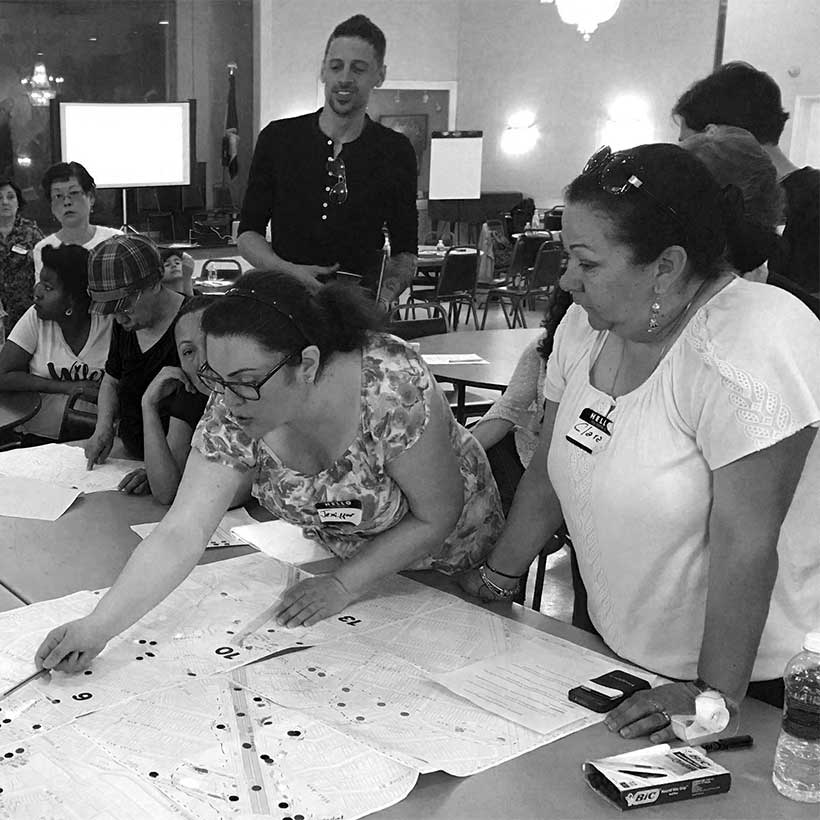 members at a Livable Neighborhoods workshop inspect a map