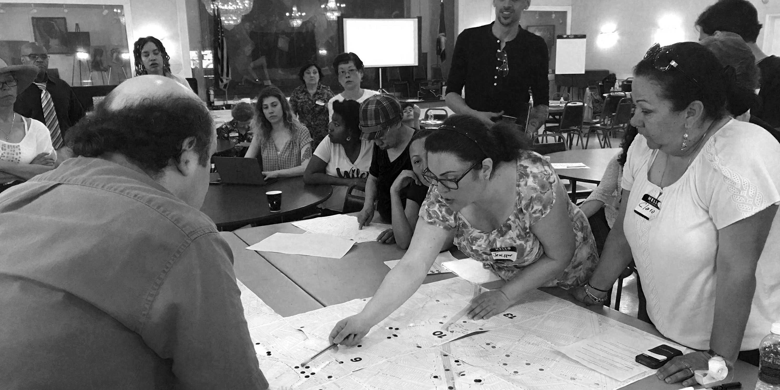 members at a Livable Neighborhoods workshop inspect a map
