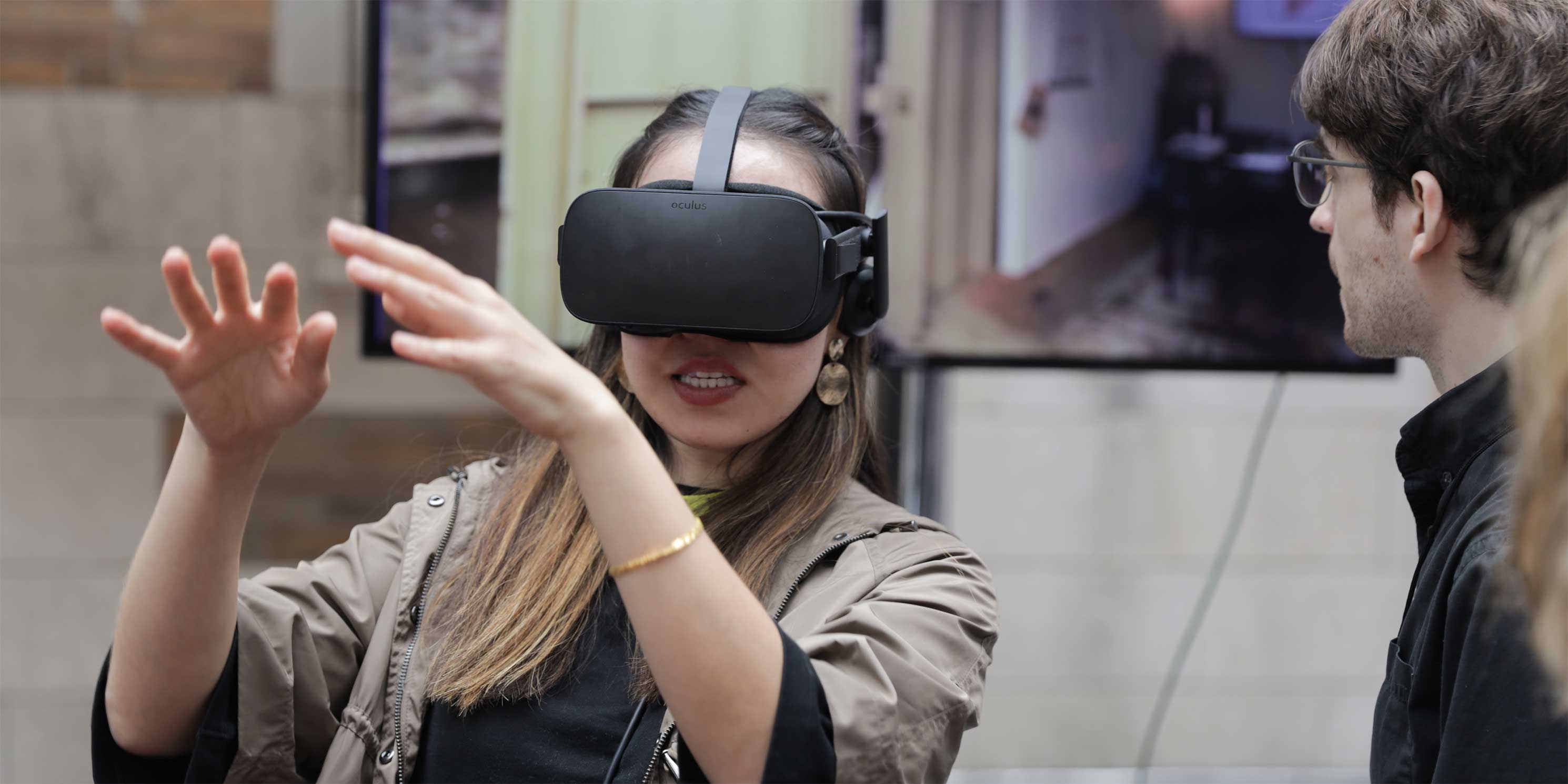 a woman wears virtual reality goggles at the Summit