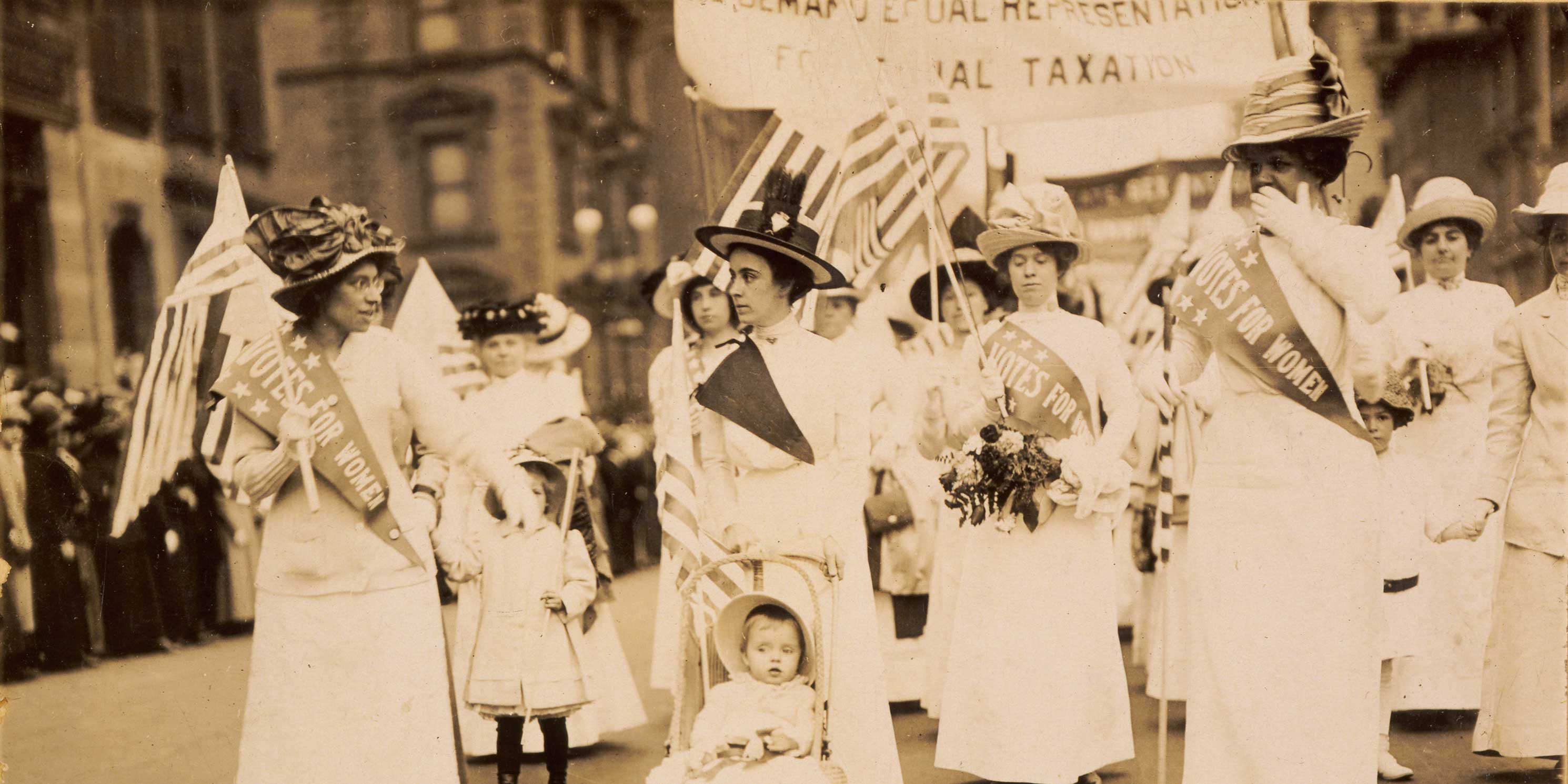 woman and their children in a suffrage parade