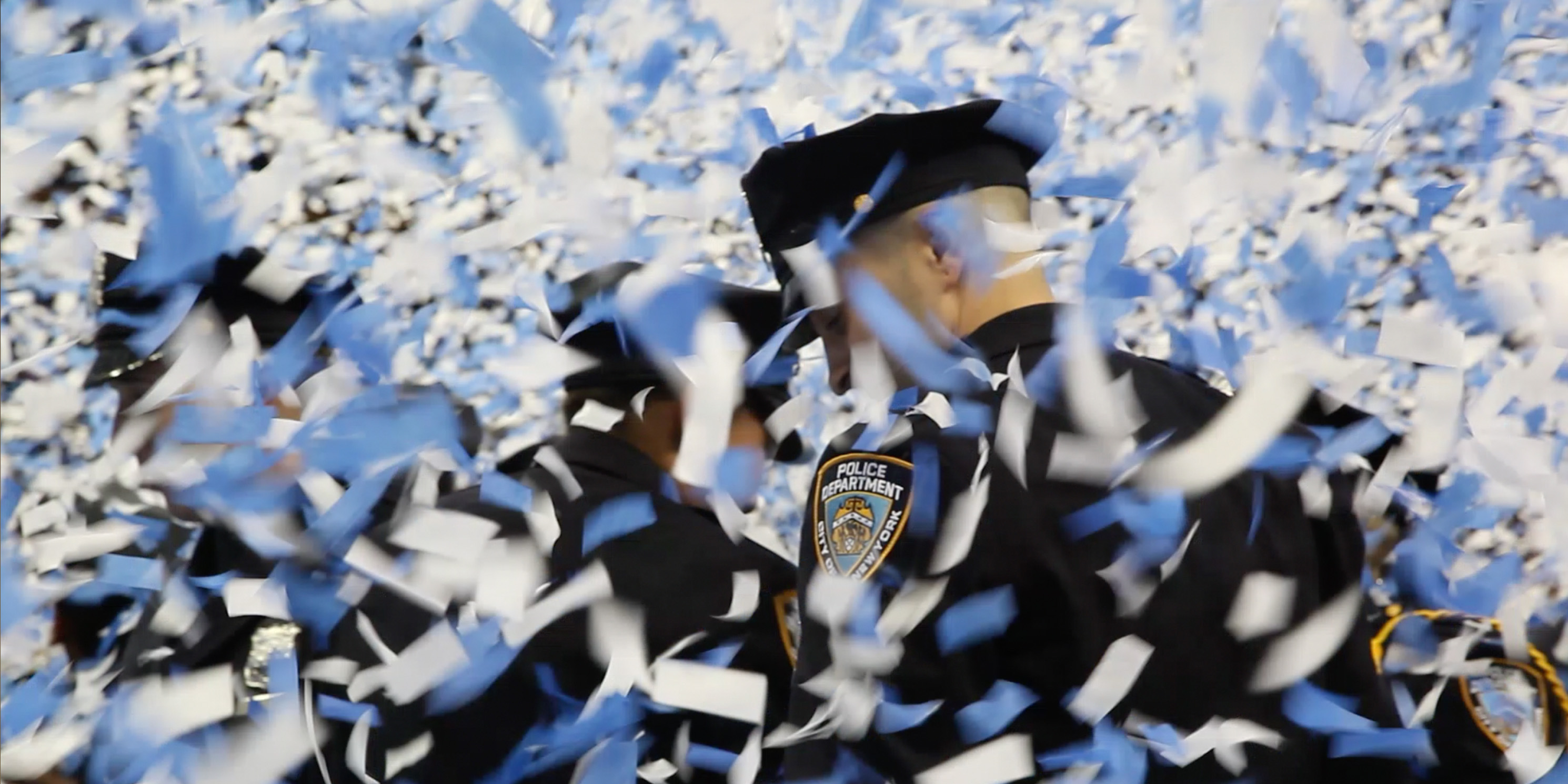 still from the movie Crime and Punishment, police officer walk through ticker tape