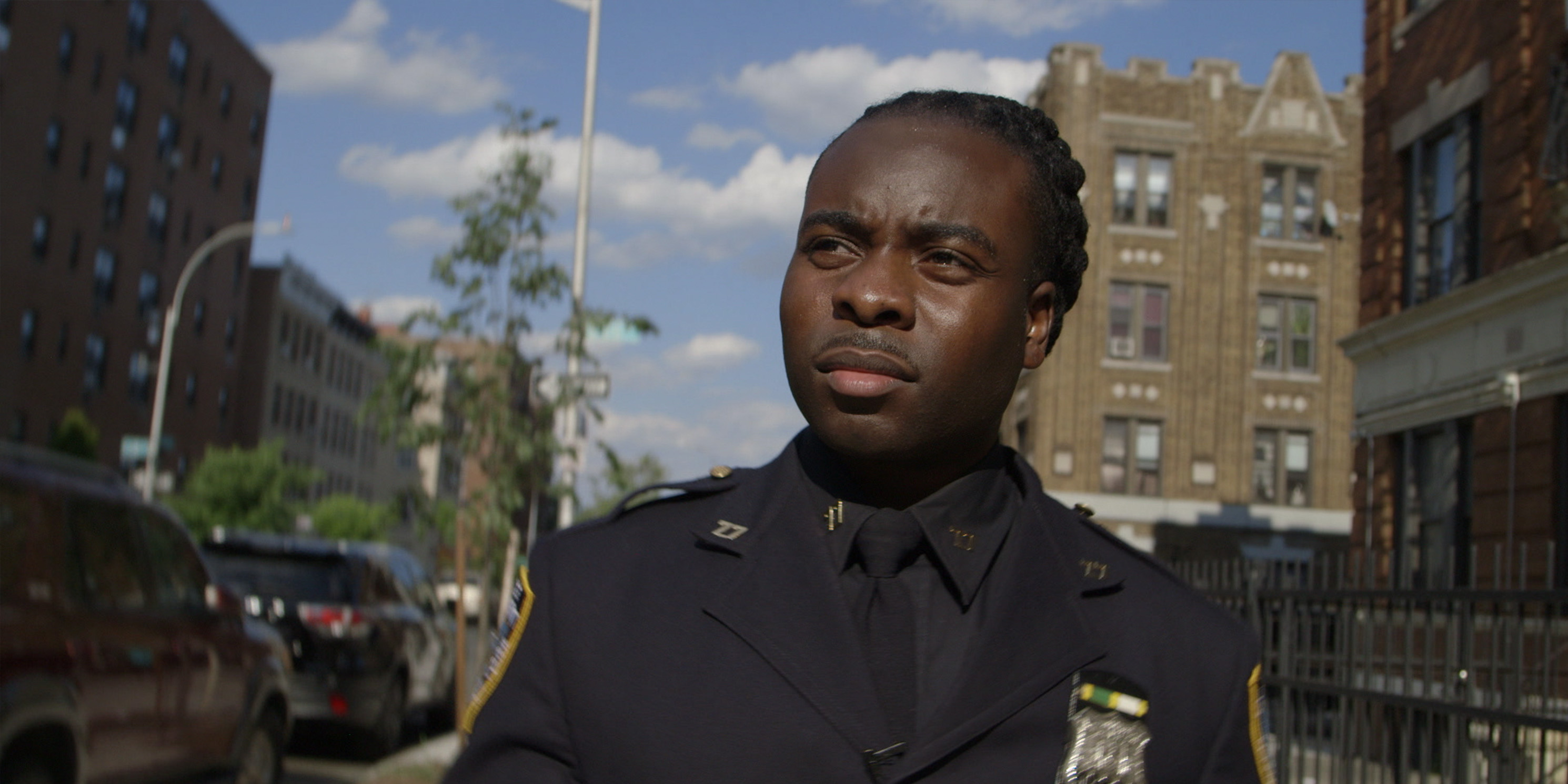 still from the movie Crime and Punishment, police officer walks on street