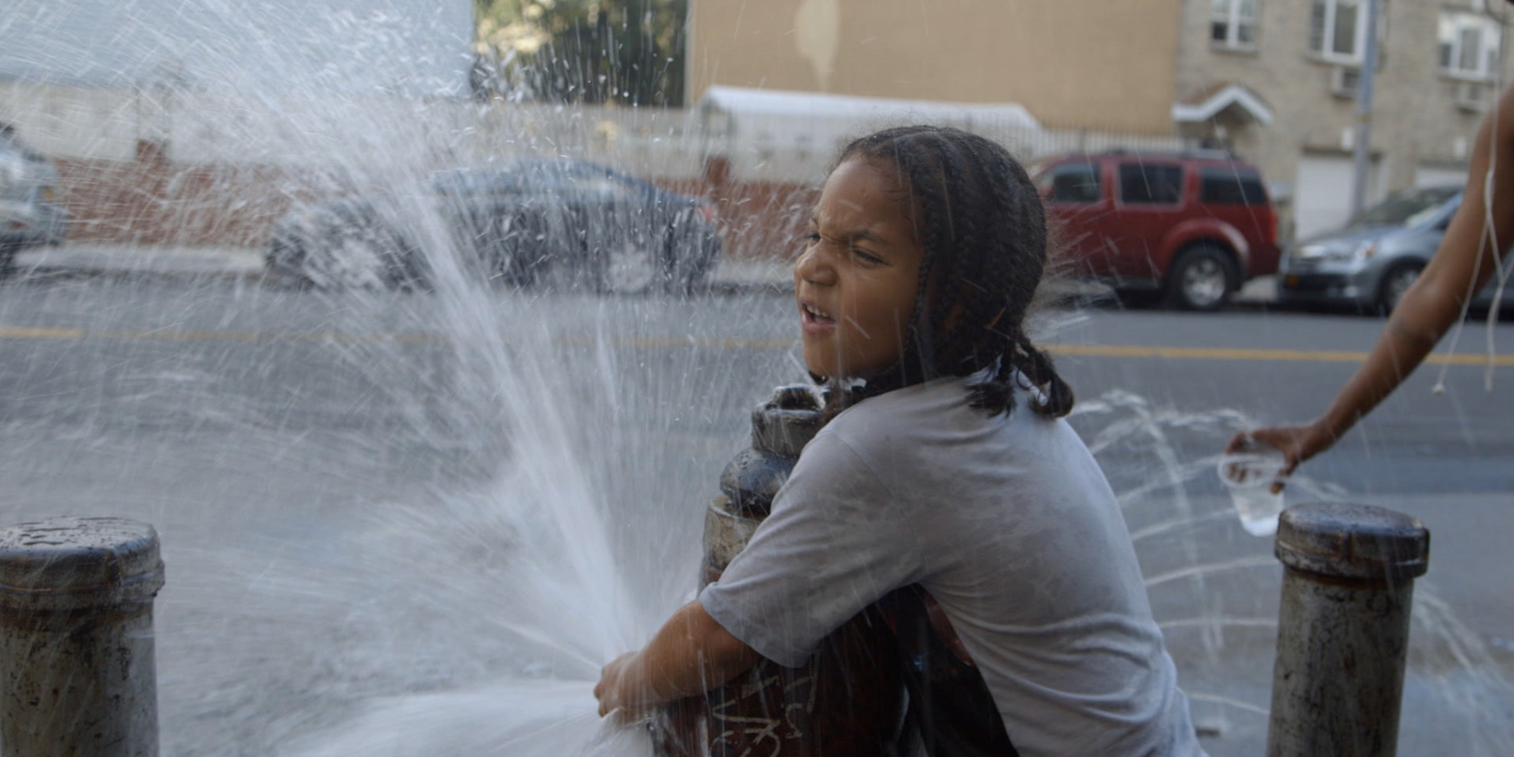 still from the movie Crime and Punishment, child plays at fire hydrant