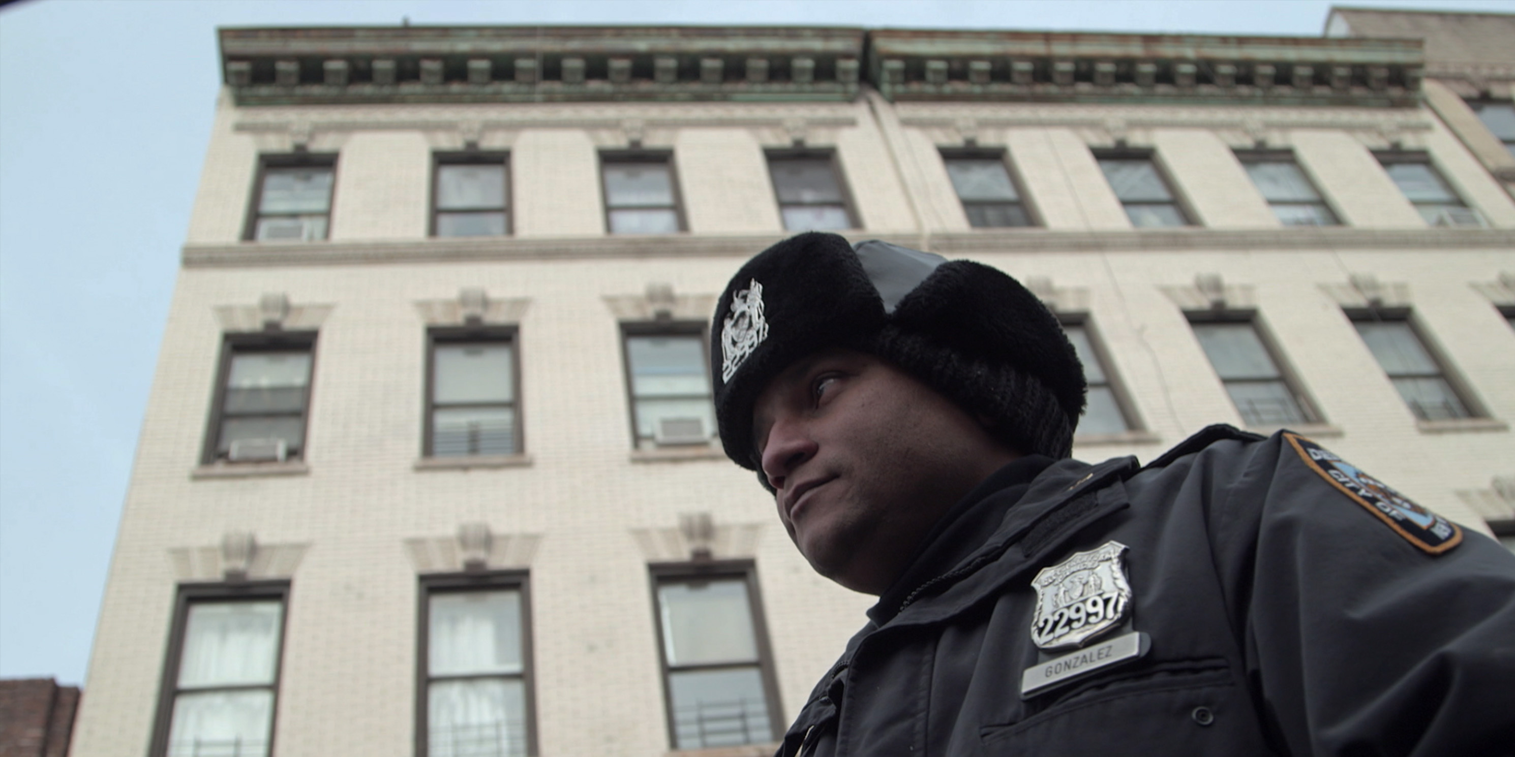 still from the movie Crime and Punishment, police officer outside building