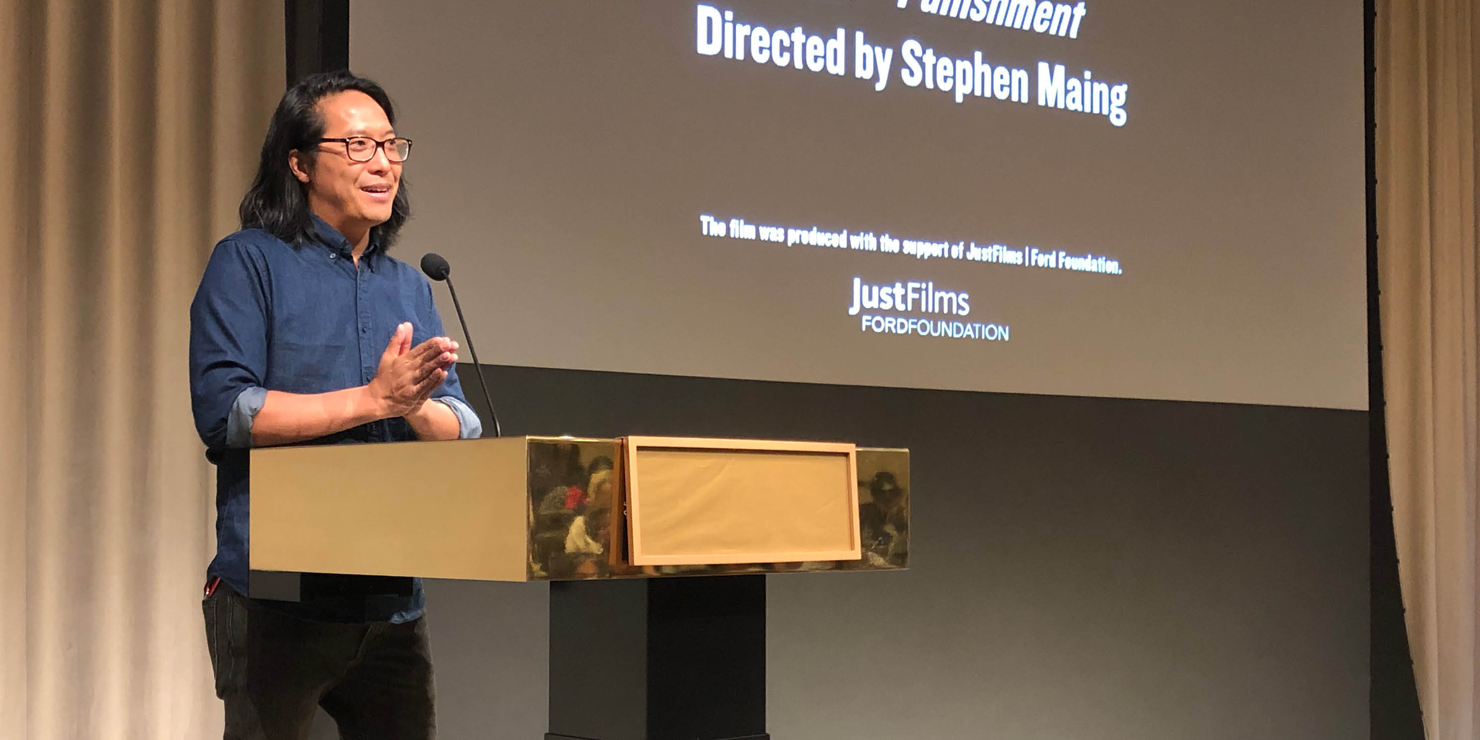 Director Stephen Maing speaks during a screening of the movie Crime and Punishment