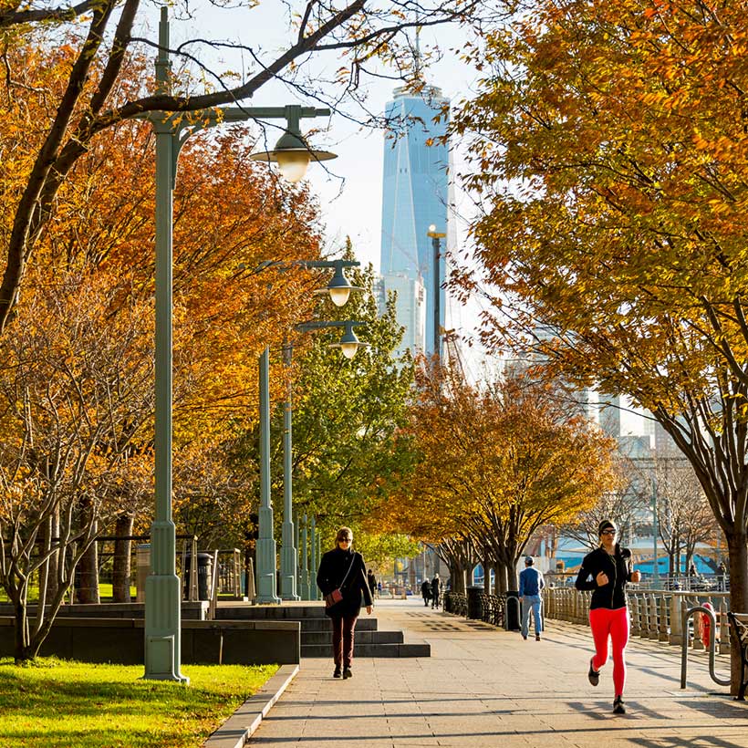 joggers run through Hudson River Park in Autumn