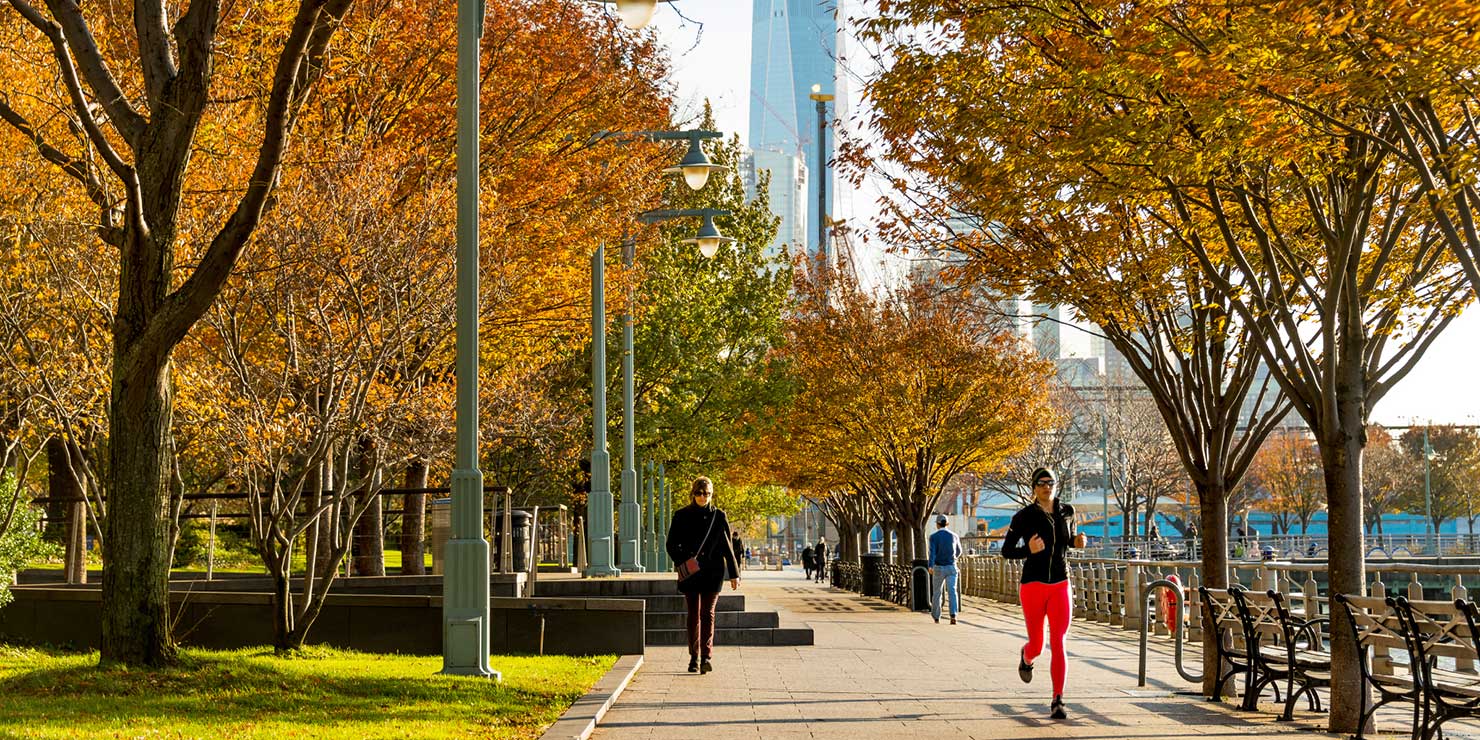 joggers run through Hudson River Park in Autumn