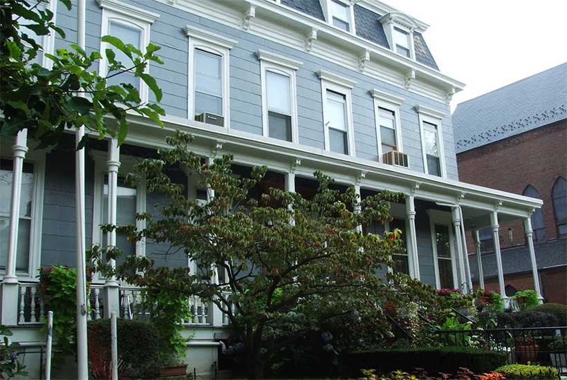 wooden home with porch in Stuyvesant Heights