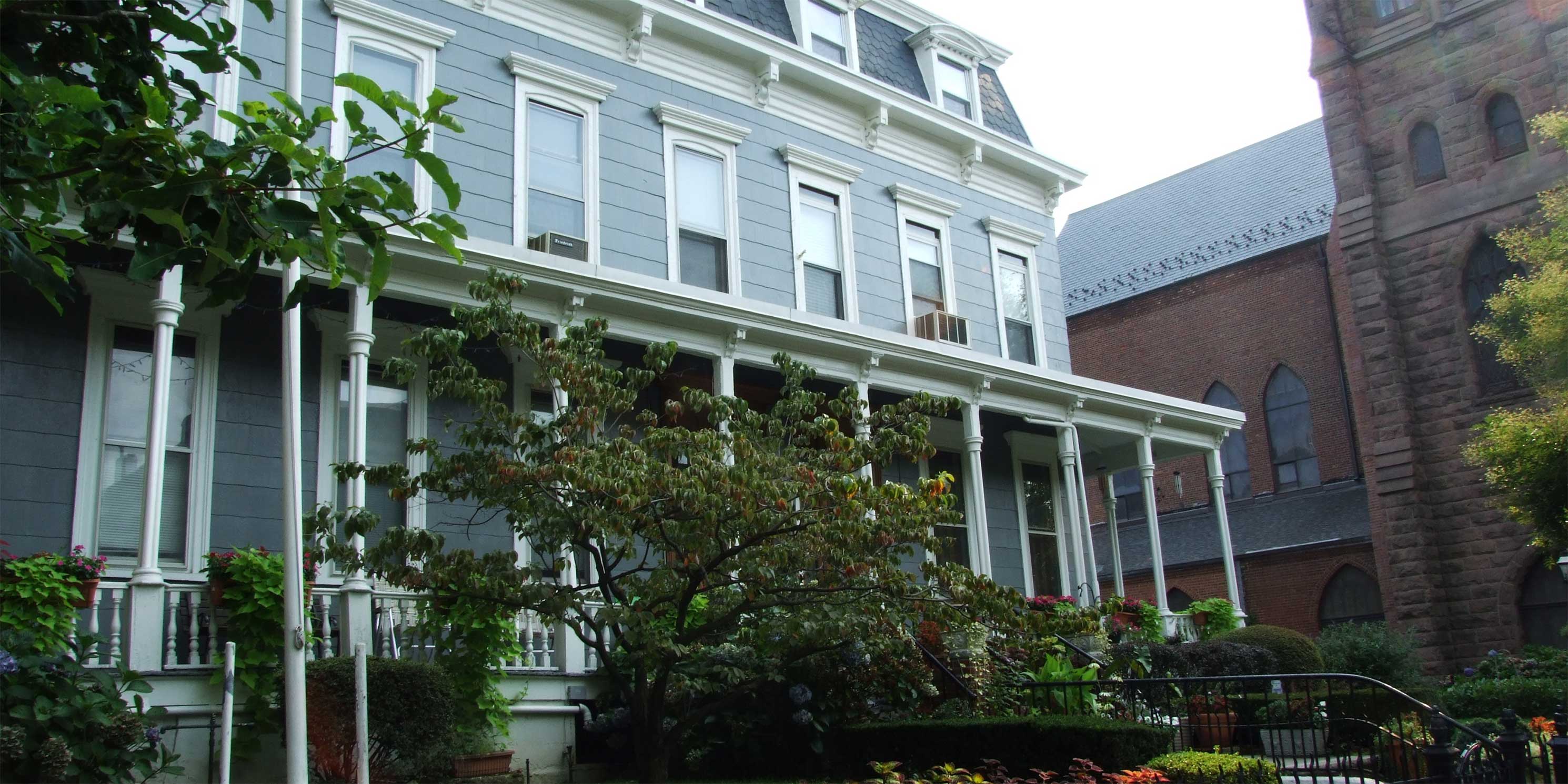 wooden home with porch in Stuyvesant Heights