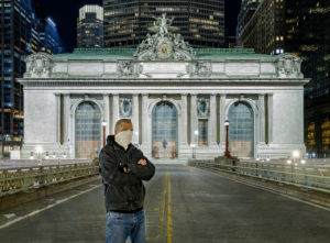 Giles Ashford stands in front of Grand Central Terminal at night