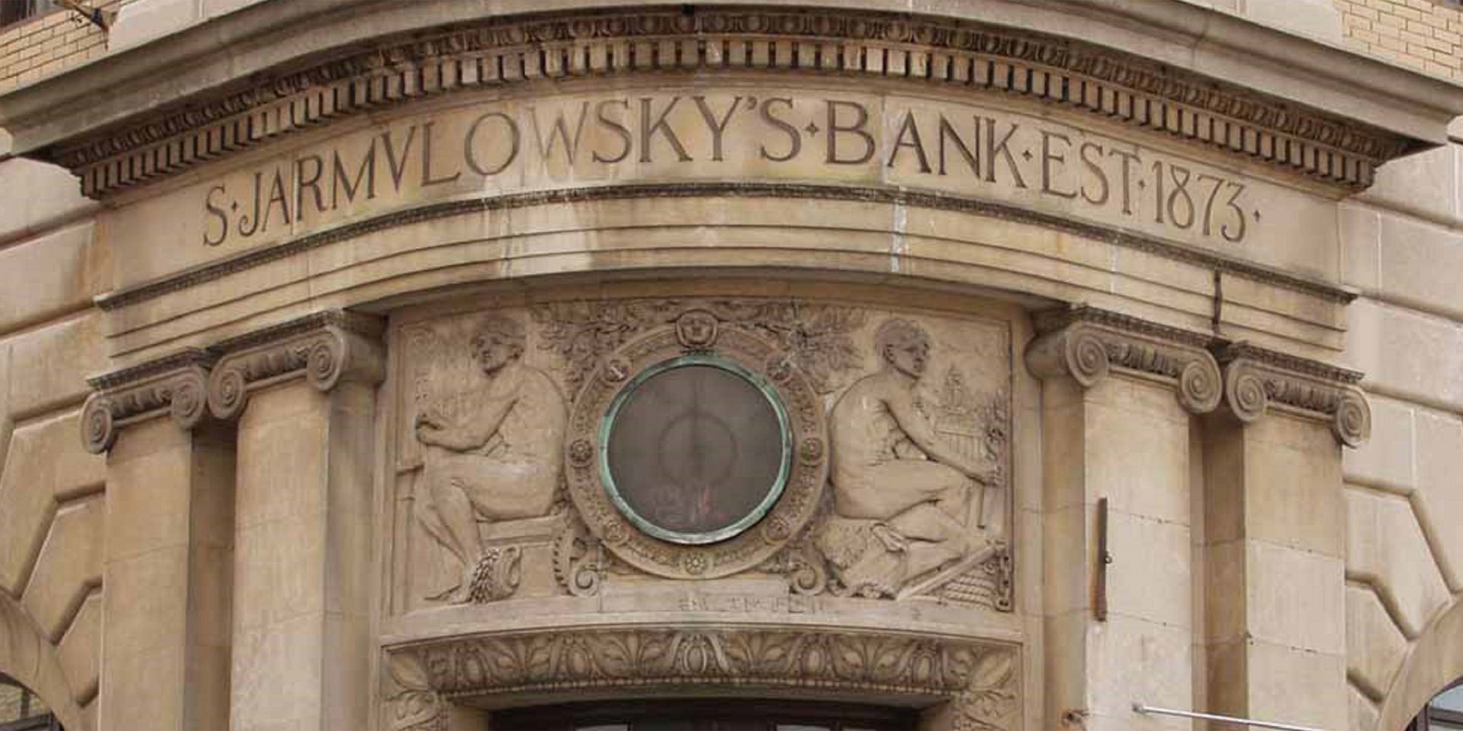 sign for Jarmulowsky Bank carved into stone facade of building