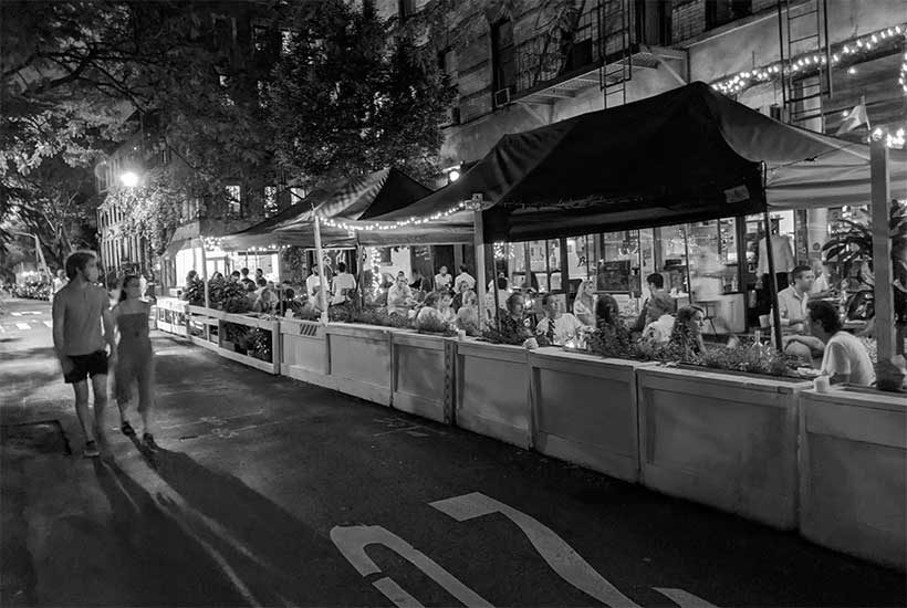 people enjoy night time outdoor dining during the COVID pandemic