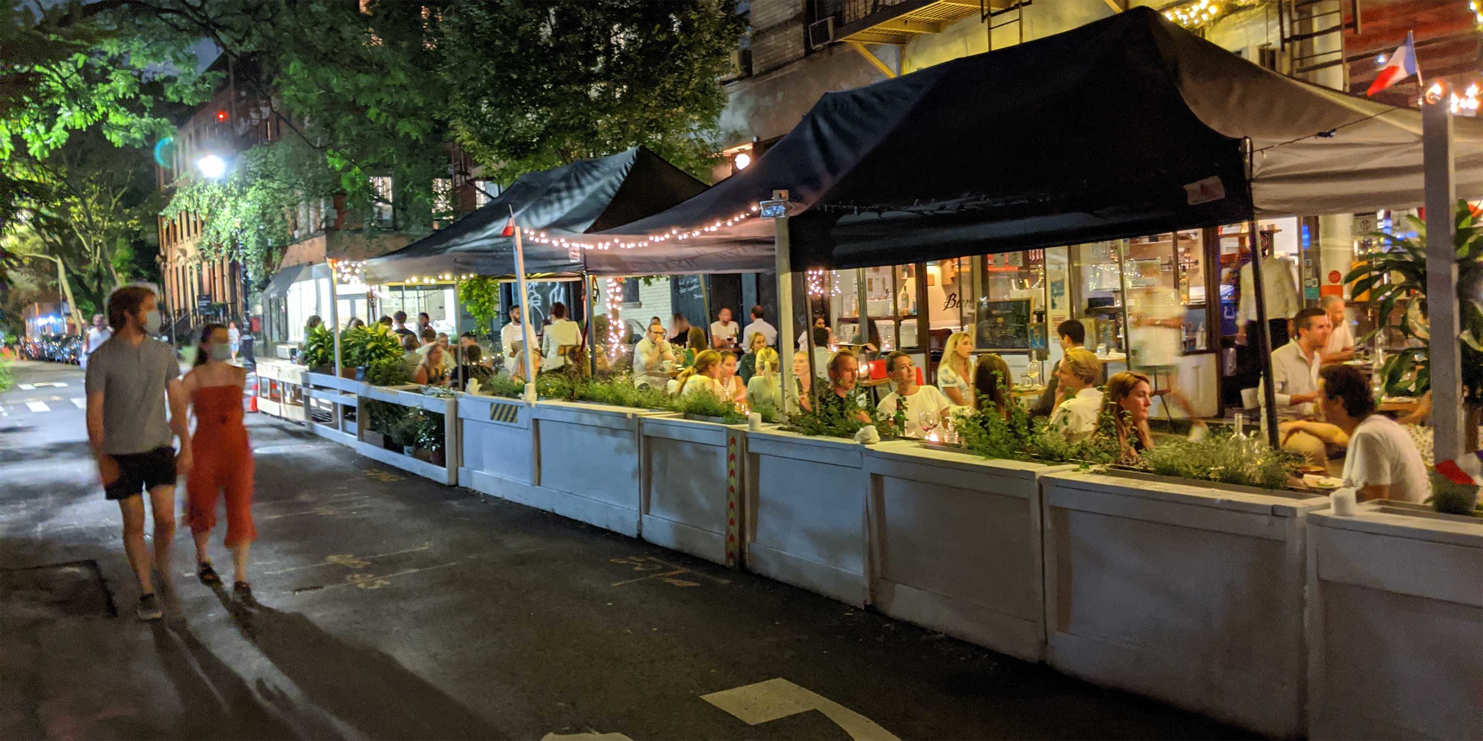 people enjoy night time outdoor dining during the COVID pandemic