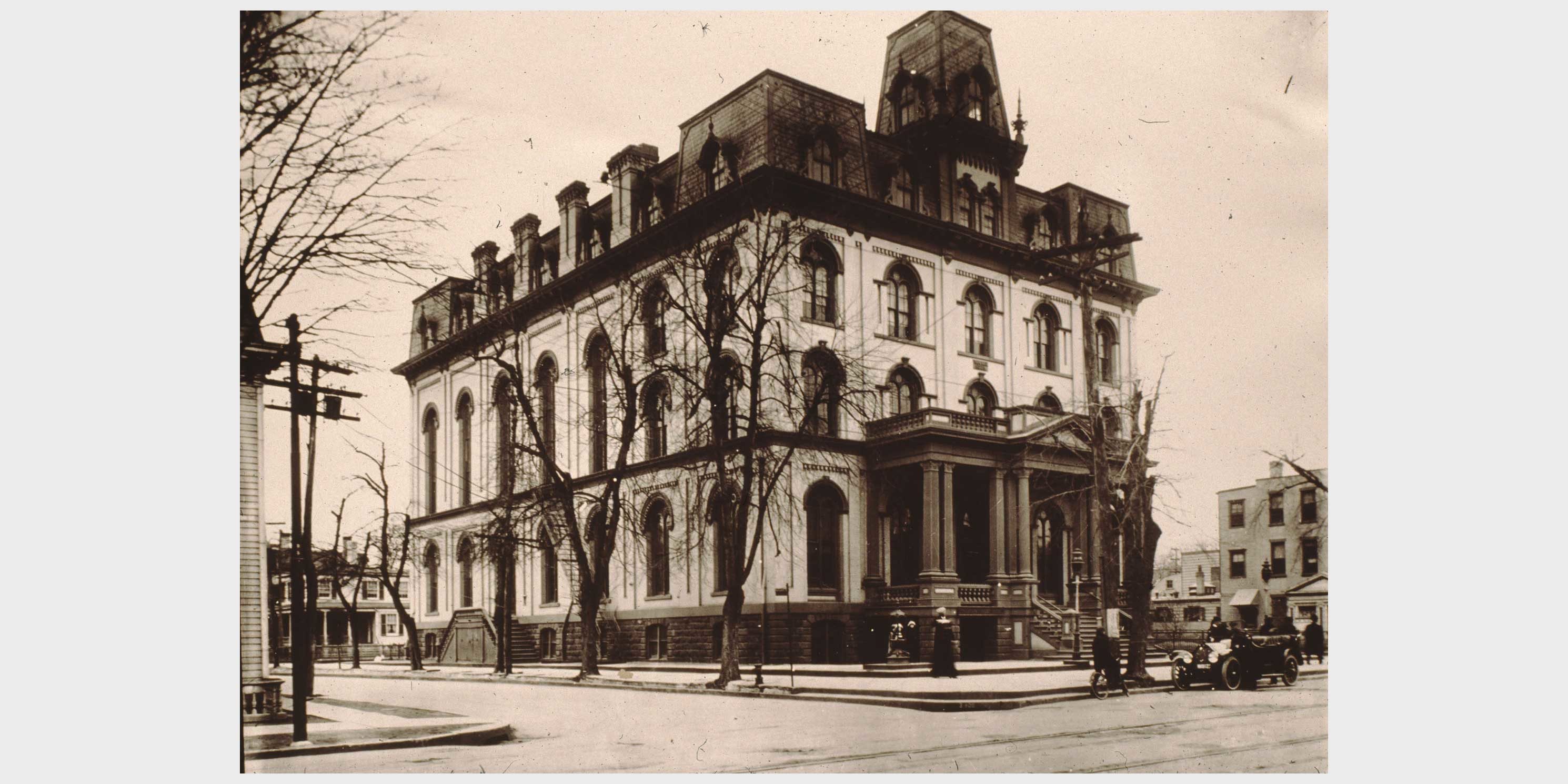 a large building and street in Jamaica, New York circa early 1900s