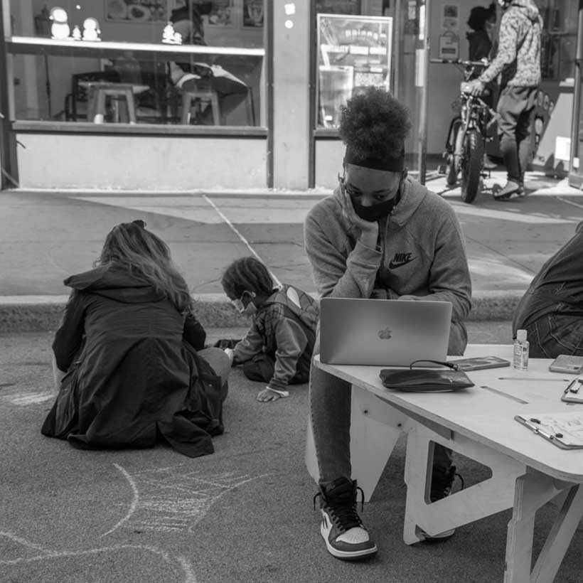 kids study outside at small tables