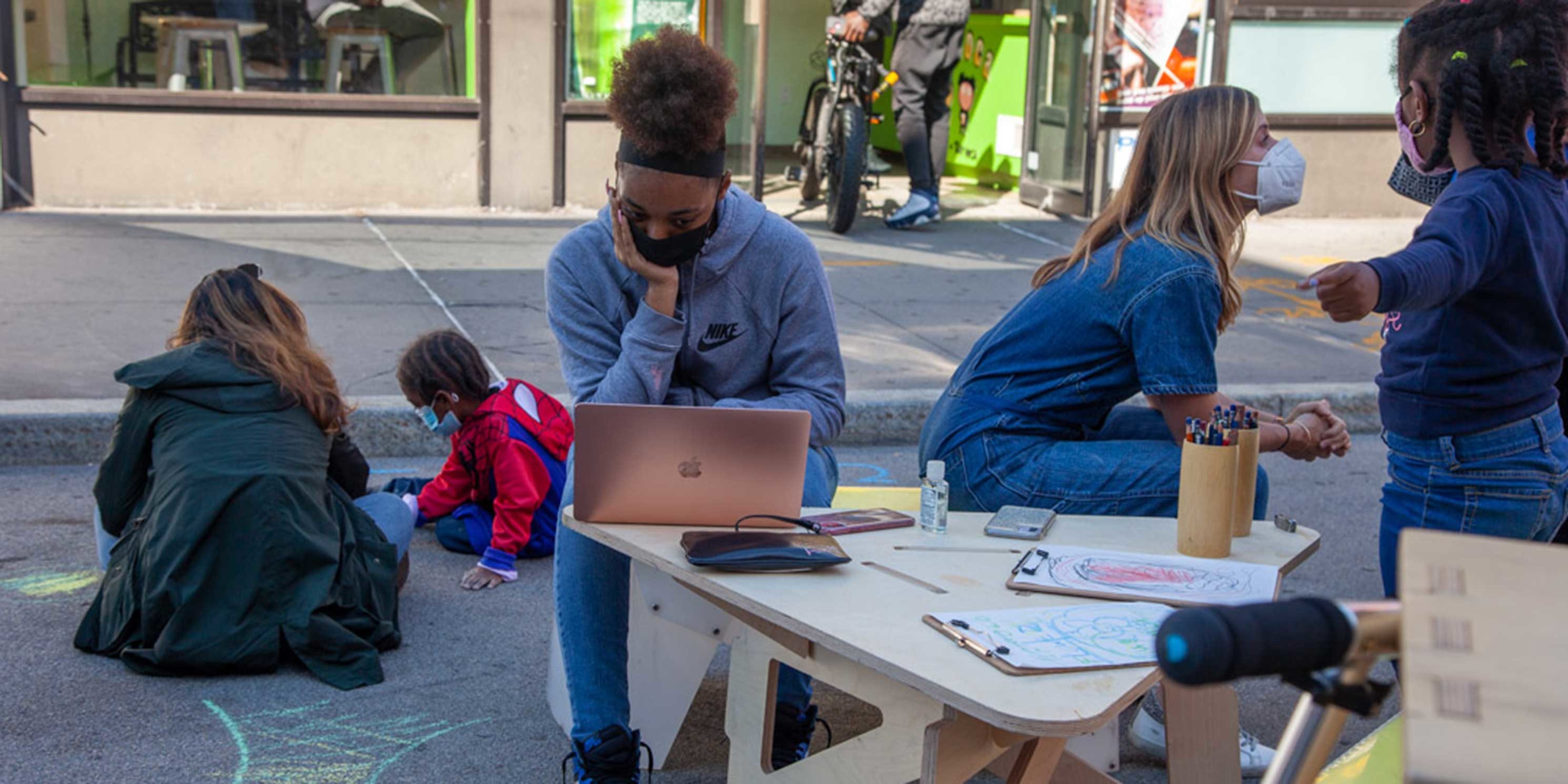 kids study outside at small tables