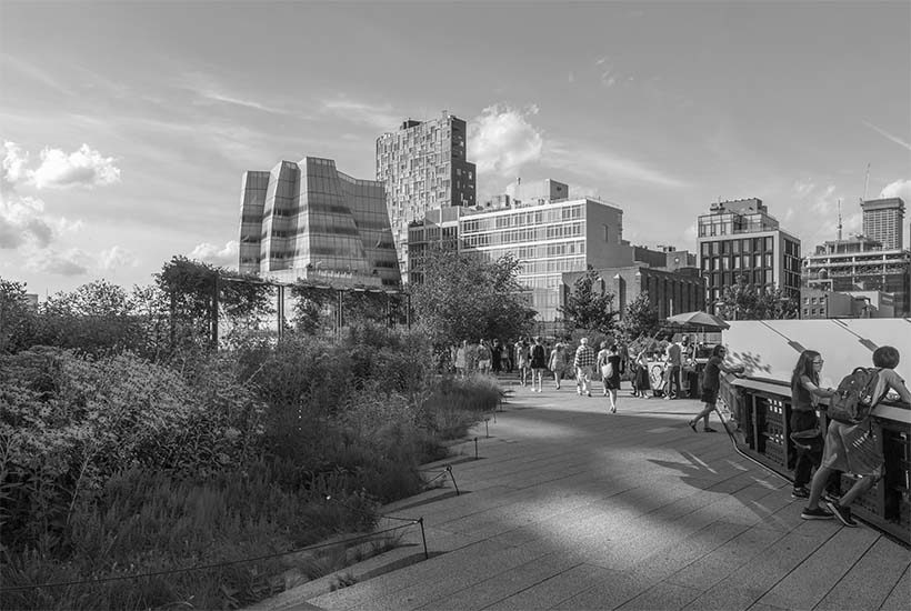 people stroll the Highline with IAC building in background